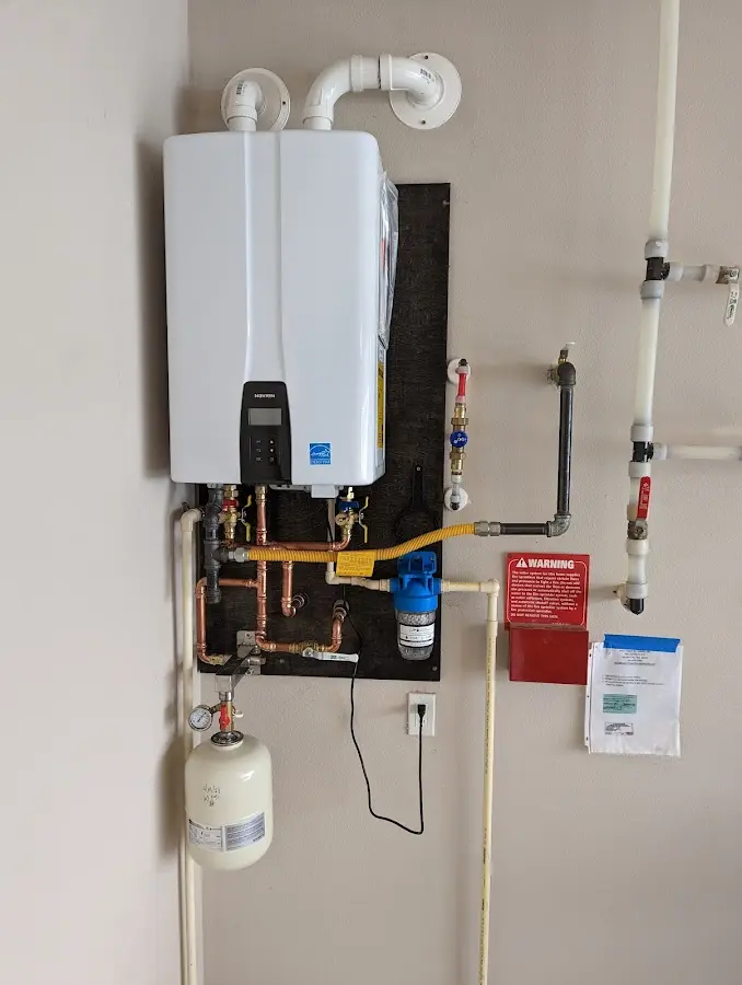 Professional plumber installing copper piping in a St. Charles home